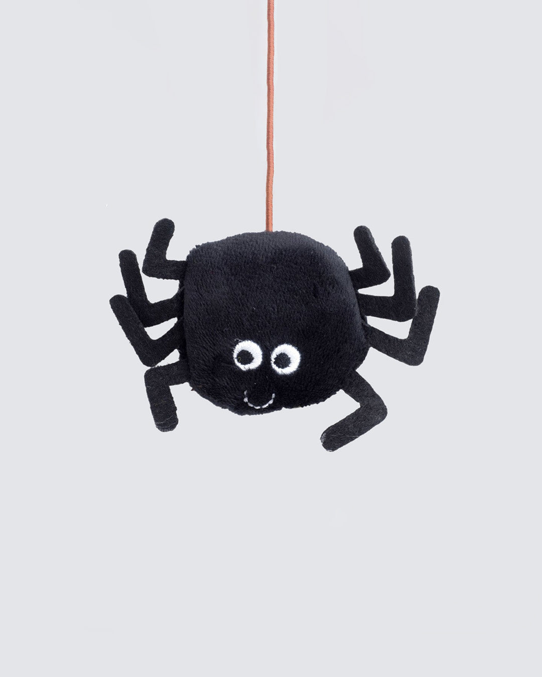 Close-up of catnip-filled black plush spider hanging from wand string