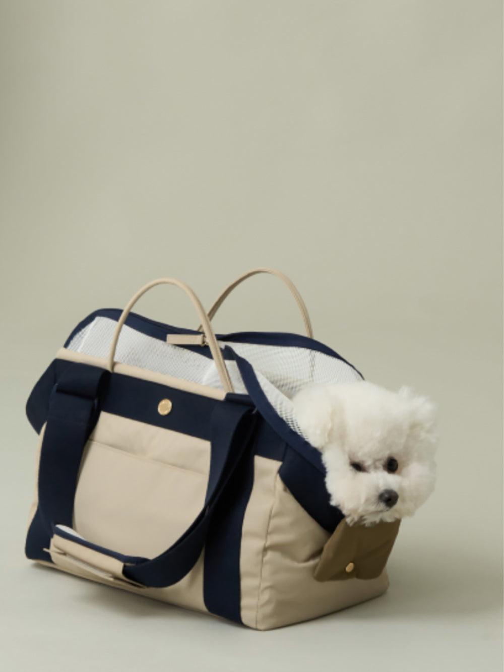 A small dog playing inside the Bagel Bag pet carrier.