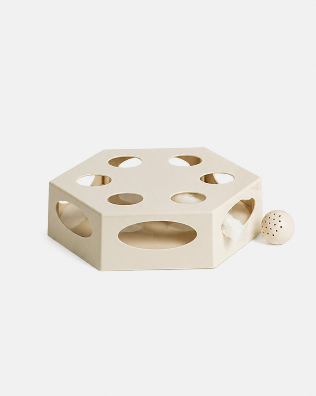 Beige geometric automatic cat toy with multiple holes for indoor cats.