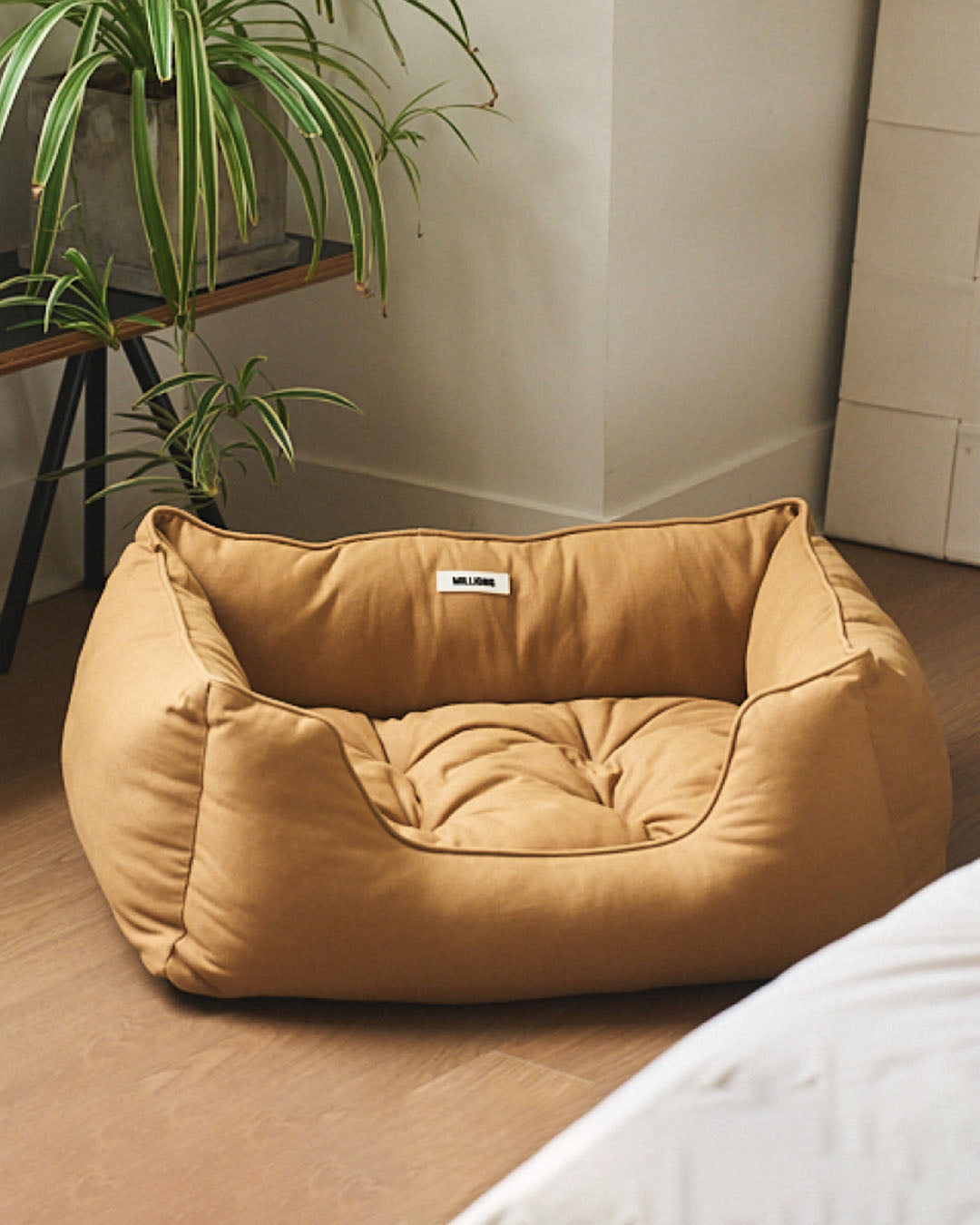 Minimalist camel-colored cat and dog bed that fits seamlessly into modern living rooms.