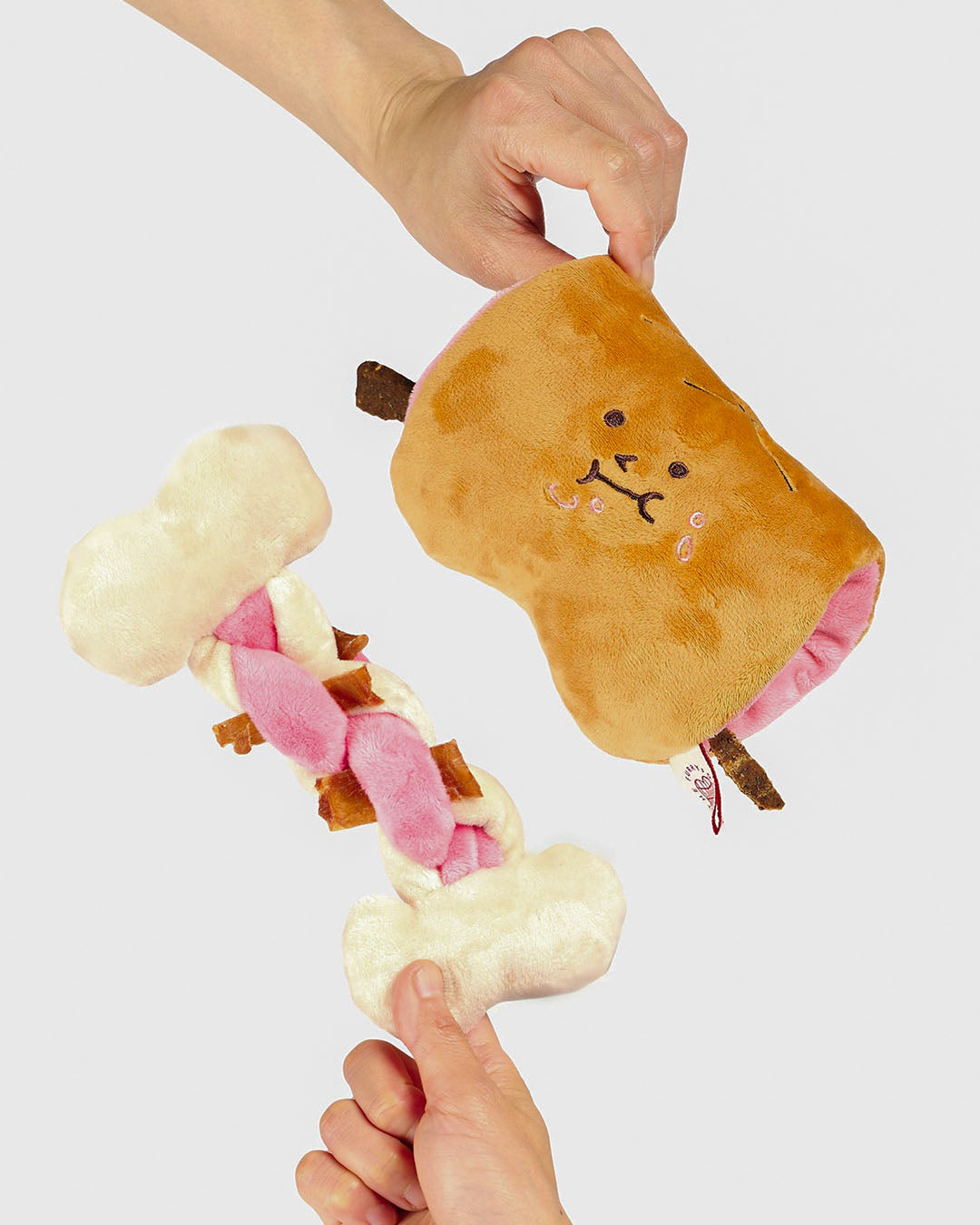 Two-piece Bone Appétit nosework dog toy with plush bone and braided rope insert