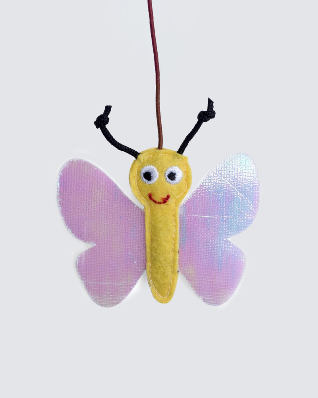 Close-up of catnip-filled plush butterfly hanging from wand string