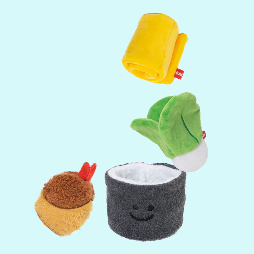 Close-up of the plush egg roll and spinach, designed with hidden pockets to conceal treats for interactive play.