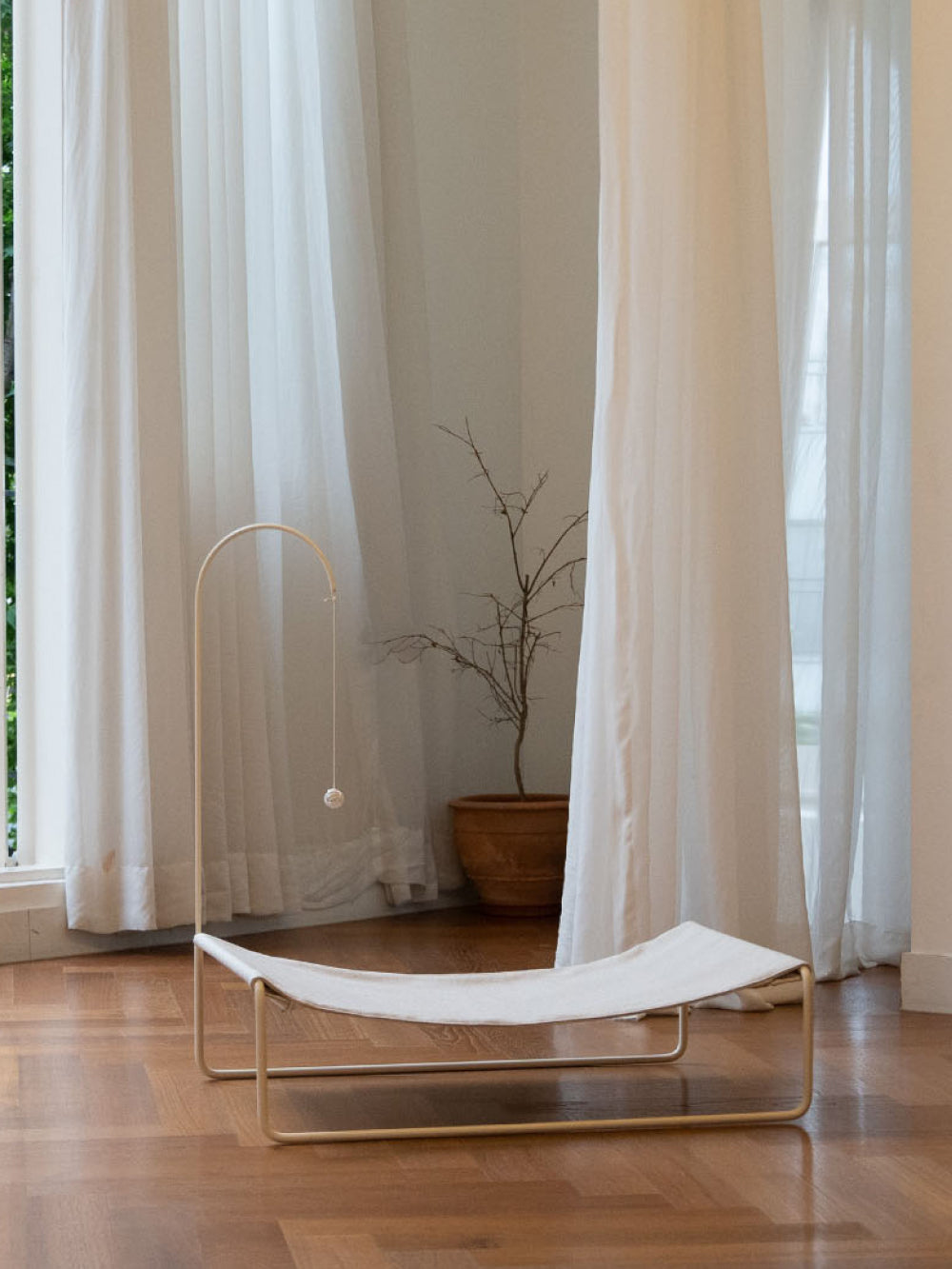 Lullaby Hammock placed in a modern living room, blending seamlessly with contemporary decor.