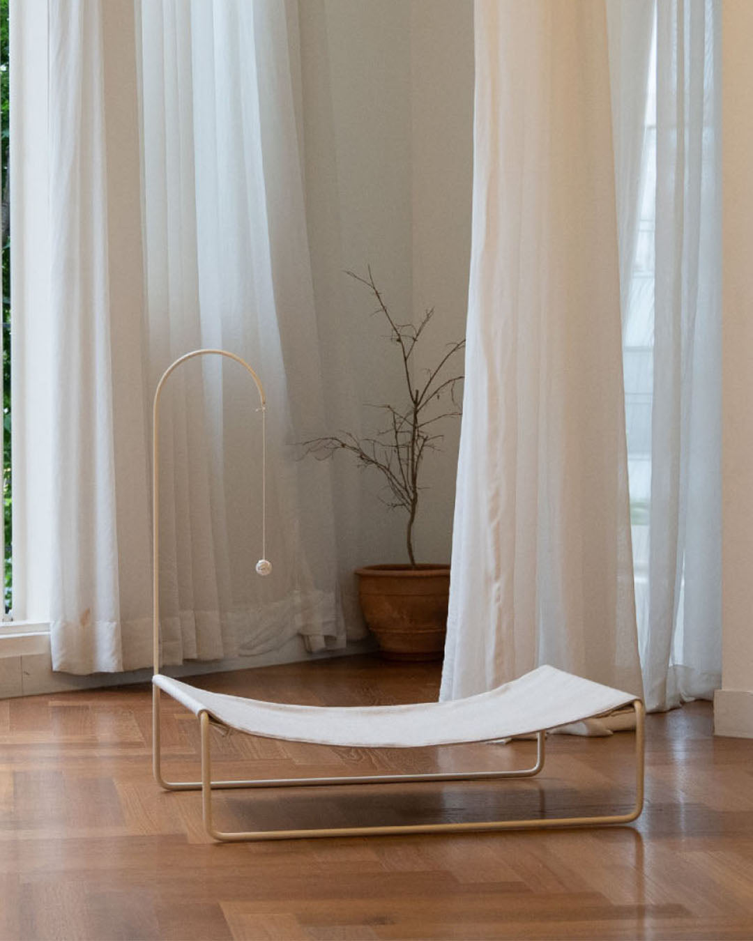 Lullaby Hammock placed in a modern living room, blending seamlessly with contemporary decor.
